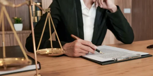 estate lawyer reviewing a legal document with scales of justice on the desk